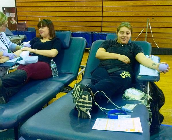 Seniors Brittany Cochrane and Kayla Clarke perform the kind act of donating blood.