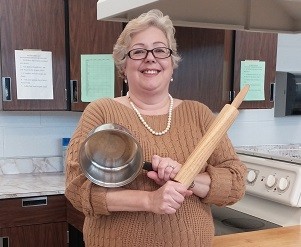 Mrs. Marut helps her students cook mashed potatoes and potato salad.