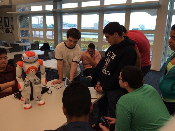 The Robotics Club members work on programming the robot to dance.