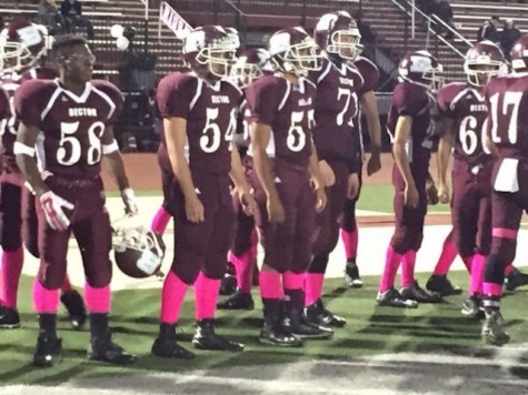 The football team wears pink socks in honor of breast cancer awareness.