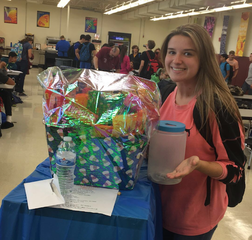 Junior Lauren Kaszka collects raffle tickets for the Halloween Basket Fundraiser.