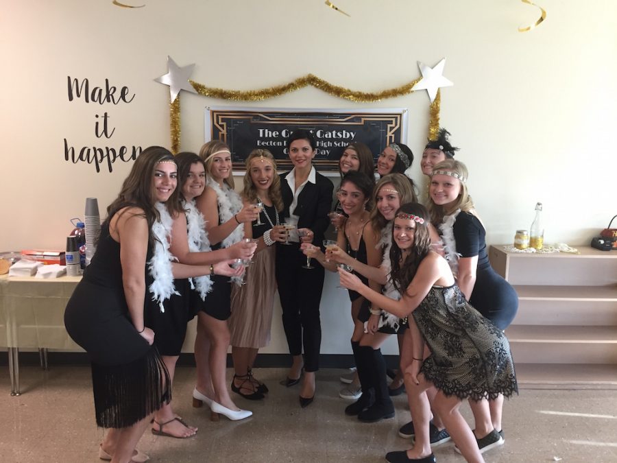 Mrs. Gatto and her students make a toast to the 1920s.