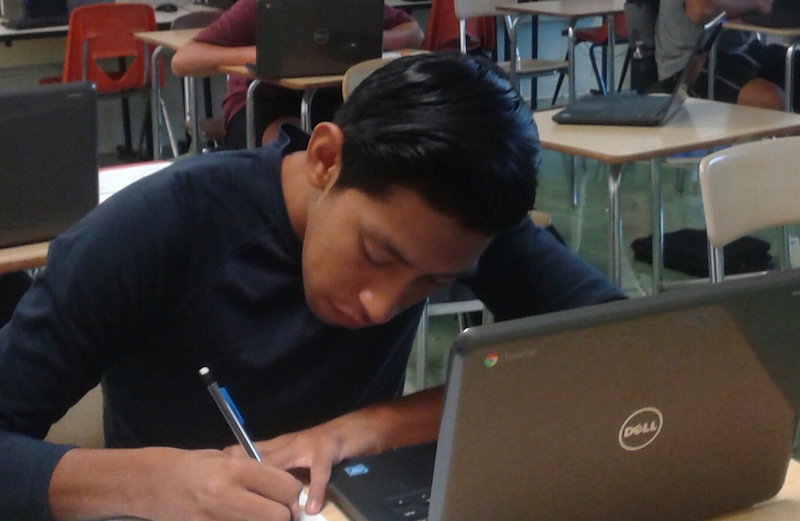 Becton Sophomore Andri Barrios uses his Chromebook to complete research in English class.