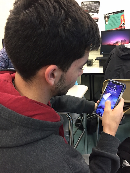 Senior Jaime Mesa takes a look at his classmates IPhone X.
