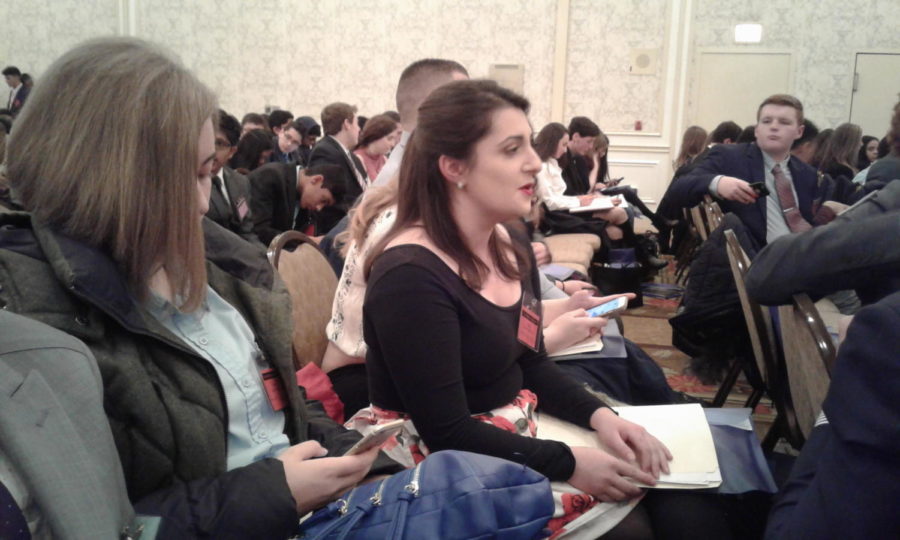 Senior Victoria Gatopoulos engages in conversation with a fellow delegate.