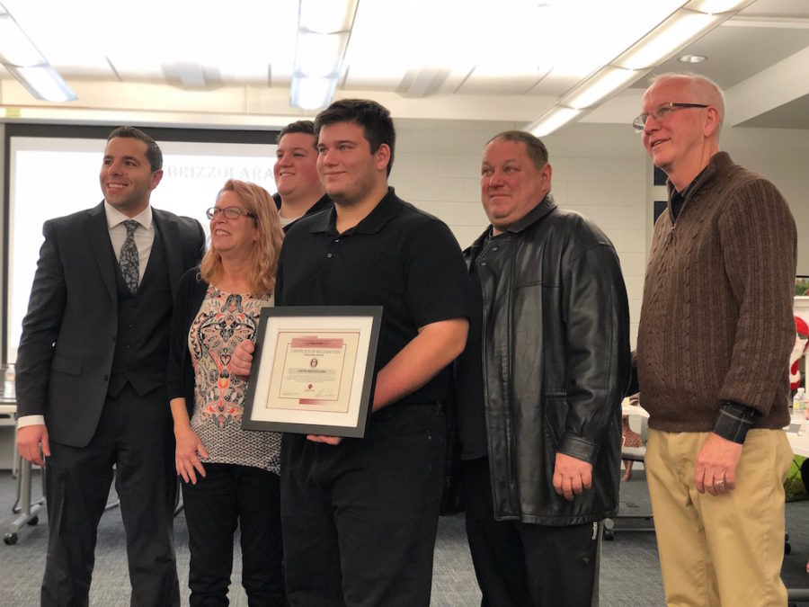 Senior David Brizzolara receives the Act of Kindness Award at the December board of education meeting alongside his family, Dr. Sforza and Becton BOE President Mr. Robert Anderson.