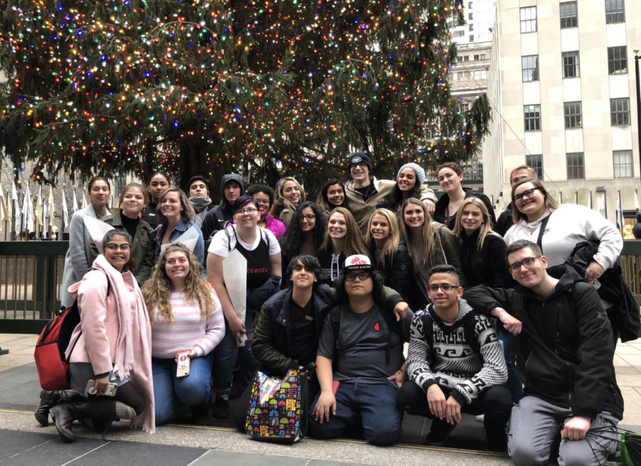 Students gather around the Rockefeller Center tree after lunch.