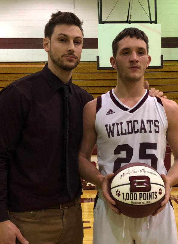 Head Varsity Basketball Coach Dan Balaban congratulates Nicholas Monahan after he nets his 1,000th point.