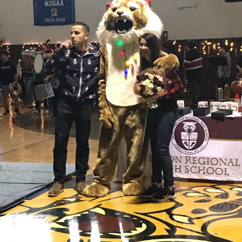 Dr. Sforza and the Wildcat Mascot award Mrs. Colangelo with Teacher of the Year!