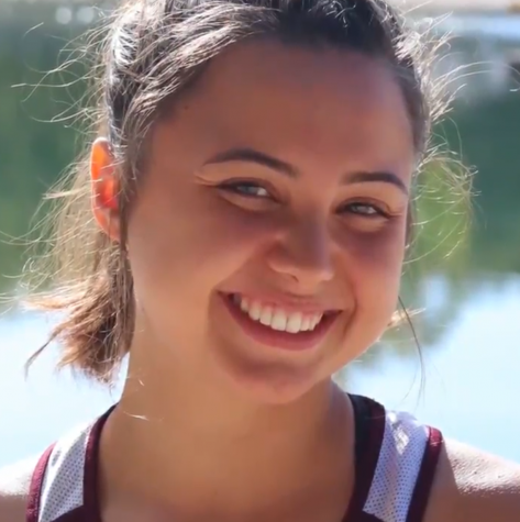 JulieAnne Fossett smiles in her track uniform, as April's Student of the Month.