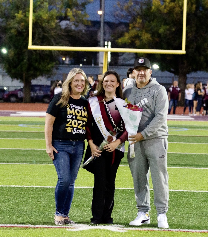 Senior Captain of Color Guard, Madison Knueppel, with her supportive family on Senior Night.