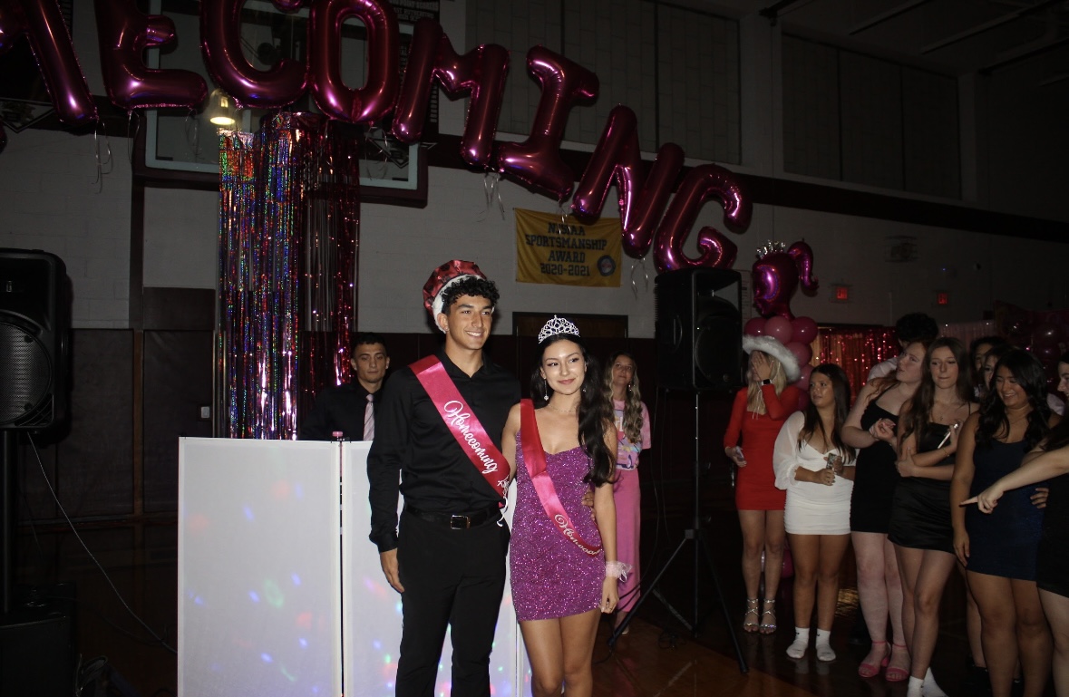 Homecoming King, Salvatore Penna, and Homecoming Queen, Skyla Tallakson, get honored with applause from their peers at the dance. 
